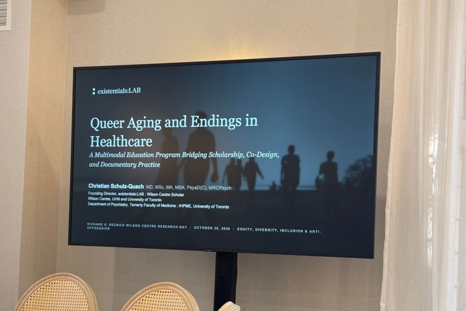 A screen showing the title slide: Queer Aging and Endings in Healthcare, a multimodal education program bridging scholarship, co-design and documentary practice.